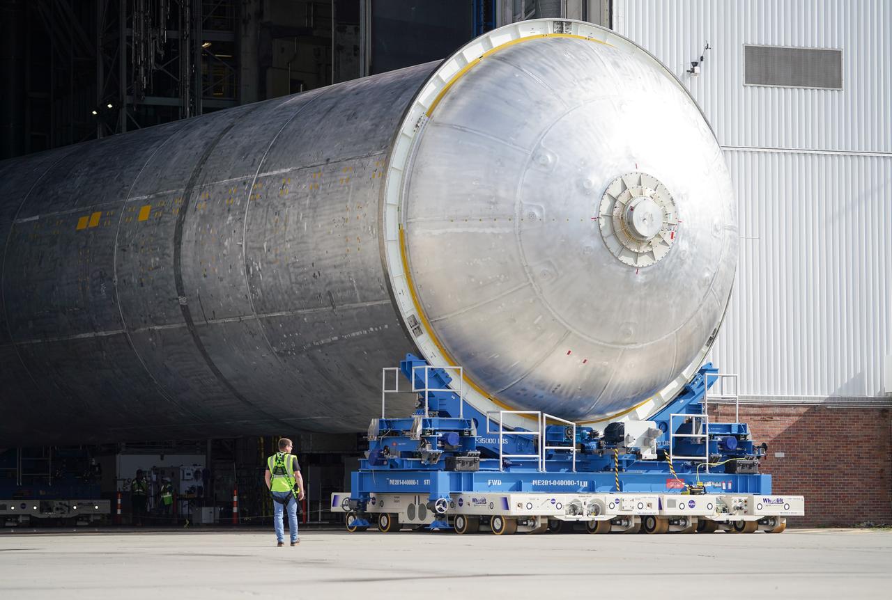 Teams move the core stage liquid hydrogen tank for the Artemis III mission to a priming cell near the Vertical Assembly Building at NASA’s Michoud Assembly Facility in New Orleans Nov. 21. Technichians will sand down and prepare the suface of the tank before coating it in a primer. Primer is applied to the barrel section of the tank by an automated robotic tool, whereas the forward and aft domes are primed manually.   Once priming is complete, technicians with NASA and Boeing, the SLS core stage prime contractor, will apply a foam-based thermal protection system, which protects the propellant tank from the extreme temperatures it will face during launch and flight while also regulating the super-chilled propellant within it. The propellant tank is one of five major elements that make up the 212-foot-tall rocket stage. The core stage, along with its four RS-25 engines, produce two million pounds of thrust to help launch NASA’s Orion spacecraft, astronauts, and supplies beyond Earth’s orbit and to the lunar surface for Artemis.   